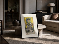 The Chariot tarot card figure print in a black frame leaning on a travertine table in a sunlit lounge