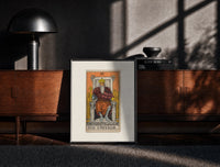 Black-framed Bearded emperor on stone throne print on a moody console with designer coffee-table books