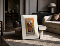 Bearded emperor on stone throne print in a black frame leaning on a travertine table in a sunlit lounge