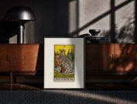 Black-framed Empress on throne with crown print on a moody console with designer coffee-table books