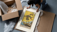 The Fool tarot card figure framed print being unpacked from protective bubble wrap and a box