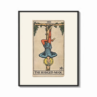 Framed Man hanging upside down from tree print shown as a bold statement piece on a clean gallery wall