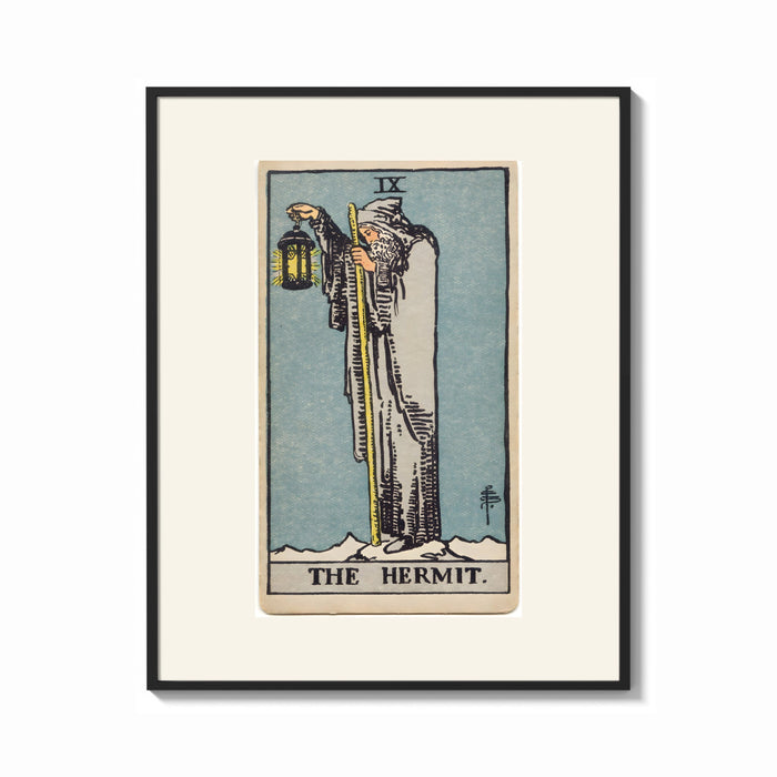Framed Cloaked hermit holding lantern and staff print shown as a bold statement piece on a clean gallery wall