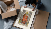 The Hierophant tarot figure on throne framed print being unpacked from protective bubble wrap and a box