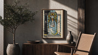 The High Priestess poster framed above a fluted sideboard beside a potted tree