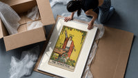 Robed magician raising a wand framed print being unpacked from protective bubble wrap and a box