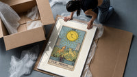 The Moon tarot card framed print being unpacked from protective bubble wrap and a box