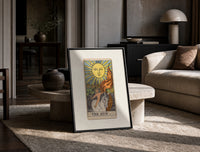 Child on white horse tarot print in a black frame leaning on a travertine table in a sunlit lounge