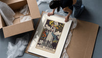 The Tower tarot card framed print being unpacked from protective bubble wrap and a box