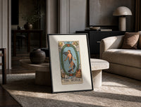 The World tarot card figure print in a black frame leaning on a travertine table in a sunlit lounge