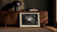Santa Claus meeting Punch at fireplace print in a black frame leaning against a walnut console in lamplight