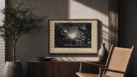 Santa Claus meeting Punch at fireplace print in a wood frame above a fluted sideboard beside an olive tree
