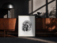 Black-framed Santa Claus hugged by young child print on a moody console with designer coffee-table books