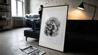 Santa Claus hugged by young child print in a slim black frame leaning on a dark sofa in a concrete print studio