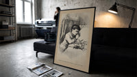 Child praying beside bed at Christmas print in a slim black frame leaning on a dark sofa in a concrete print studio