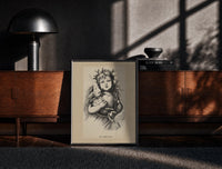 Black-framed Winged Christ child holding globe with dove print on a moody console with designer coffee-table books