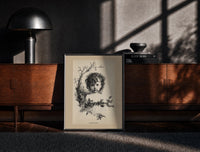 Black-framed Curly-haired child's head with holly wreath print on a moody console with designer coffee-table books