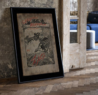 Santa in sleigh and figure riding goose print in a black frame leaning beside a vintage door on parquet