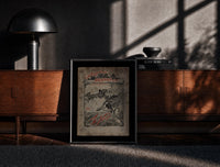 Black-framed Santa in sleigh and figure riding goose print on a moody console with designer coffee-table books