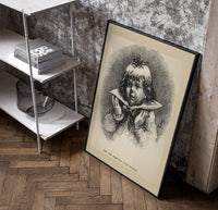 Child's face as Christmas plum pudding poster in a black frame leaning beside a shelf in a raw-plaster loft
