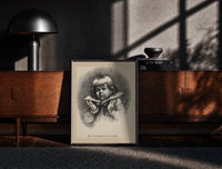 Black-framed Child's face as Christmas plum pudding print on a moody console with designer coffee-table books