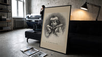 Child's face as Christmas plum pudding print in a slim black frame leaning on a dark sofa in a concrete print studio