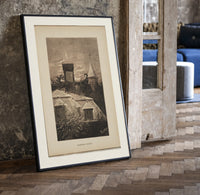 Santa Claus in sleigh on rooftop print in a black frame leaning beside a vintage door on parquet