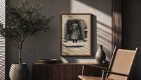 Child holding mistletoe in doorway poster framed above a fluted sideboard beside an olive tree