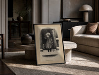 Child holding mistletoe in doorway print in a black frame leaning on a travertine table in a sunlit lounge