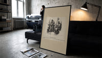 Two top-hatted men with parcels print in a slim black frame leaning on a dark sofa in a concrete print studio