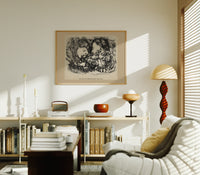 Two sleeping children's heads dreaming print in an oak frame above a mid-century book console with a vintage radio