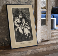 Two young children in nightgowns print in a black frame leaning beside a vintage door on parquet