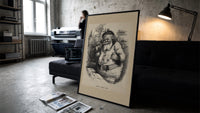 Santa Claus with pipe and telescope print in a slim black frame leaning on a dark sofa in a concrete print studio