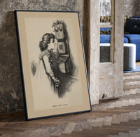 Girl speaking into wall telephone print in a black frame leaning beside a vintage door on parquet