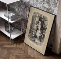 Small child reaching toward nursery wall tiles poster in a black frame leaning beside a shelf in a raw-plaster loft