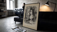 Small child reaching toward nursery wall tiles print in a slim black frame leaning on a dark sofa in a concrete print studio