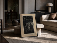 Santa Claus seated before a fireplace print in a black frame leaning on a travertine table in a sunlit lounge