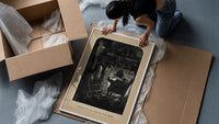 Santa Claus seated before a fireplace framed print being unpacked from protective bubble wrap and a box