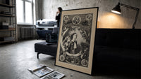 Two children awaiting Santa Claus on Christmas print in a slim black frame leaning on a dark sofa in a concrete print studio