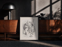 Black-framed Santa Claus meeting a shepherdess print on a moody console with designer coffee-table books