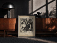 Black-framed Santa Claus scolding a small boy print on a moody console with designer coffee-table books