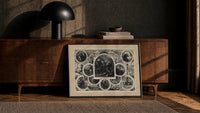 Santa Claus in vignettes of his works print in a black frame leaning against a walnut console in lamplight