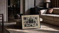 Santa Claus in vignettes of his works print in a slim black frame leaning on a travertine coffee table