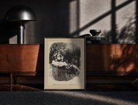Black-framed Santa Claus sitting atop snowy chimney print on a moody console with designer coffee-table books
