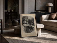 Santa Claus sitting atop snowy chimney print in a black frame leaning on a travertine table in a sunlit lounge
