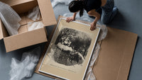 Santa Claus sitting atop snowy chimney framed print being unpacked from protective bubble wrap and a box