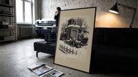 Boy watching Santa climb a chimney print in a slim black frame leaning on a dark sofa in a concrete print studio