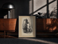Black-framed Small child seen from behind undressing print on a moody console with designer coffee-table books