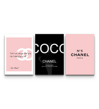 Trio of pink and black Chanel fashion posters showing CC logo, COCO lettering, and N°5 branding on a wall