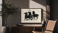 Three black horses standing print in a wood frame above a fluted sideboard beside an olive tree